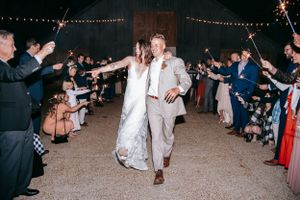 Wedding couple makes grand exit through crowd of celebrating guests.