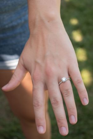 A woman's hand with an engagement ring.