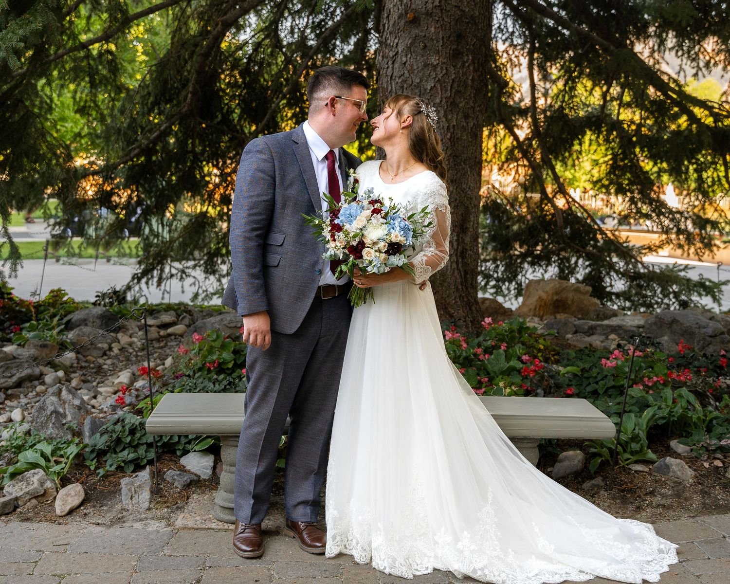 Bride in her white wedding dress in front of logan utah temple