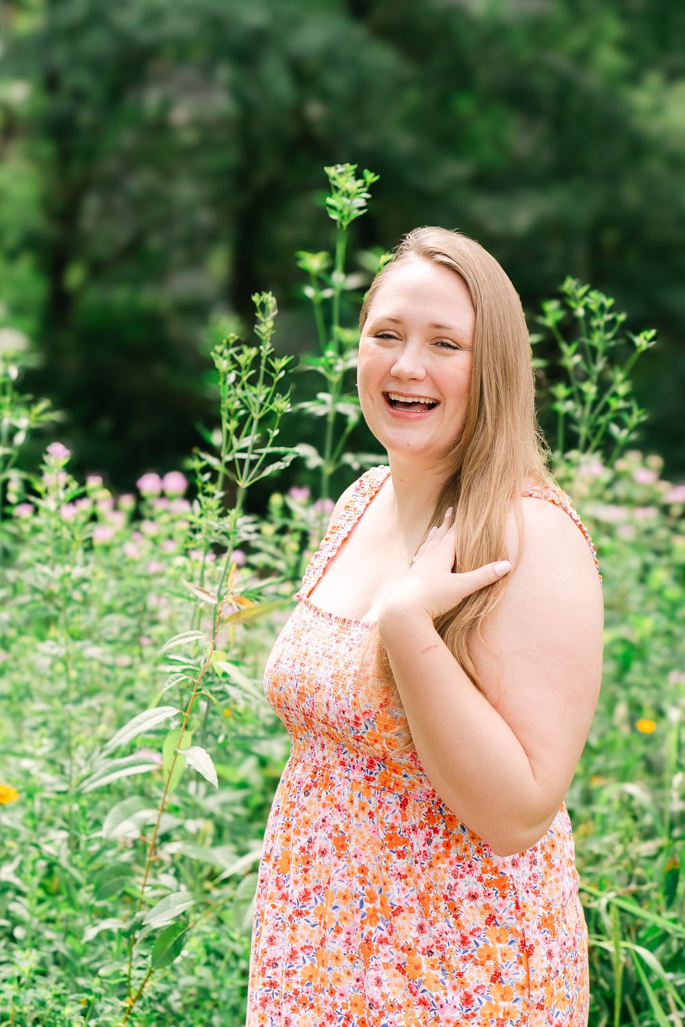 Bride-to-be laughing and smiling at the camera during a celebratory engagement gathering outside of the Twin Cities