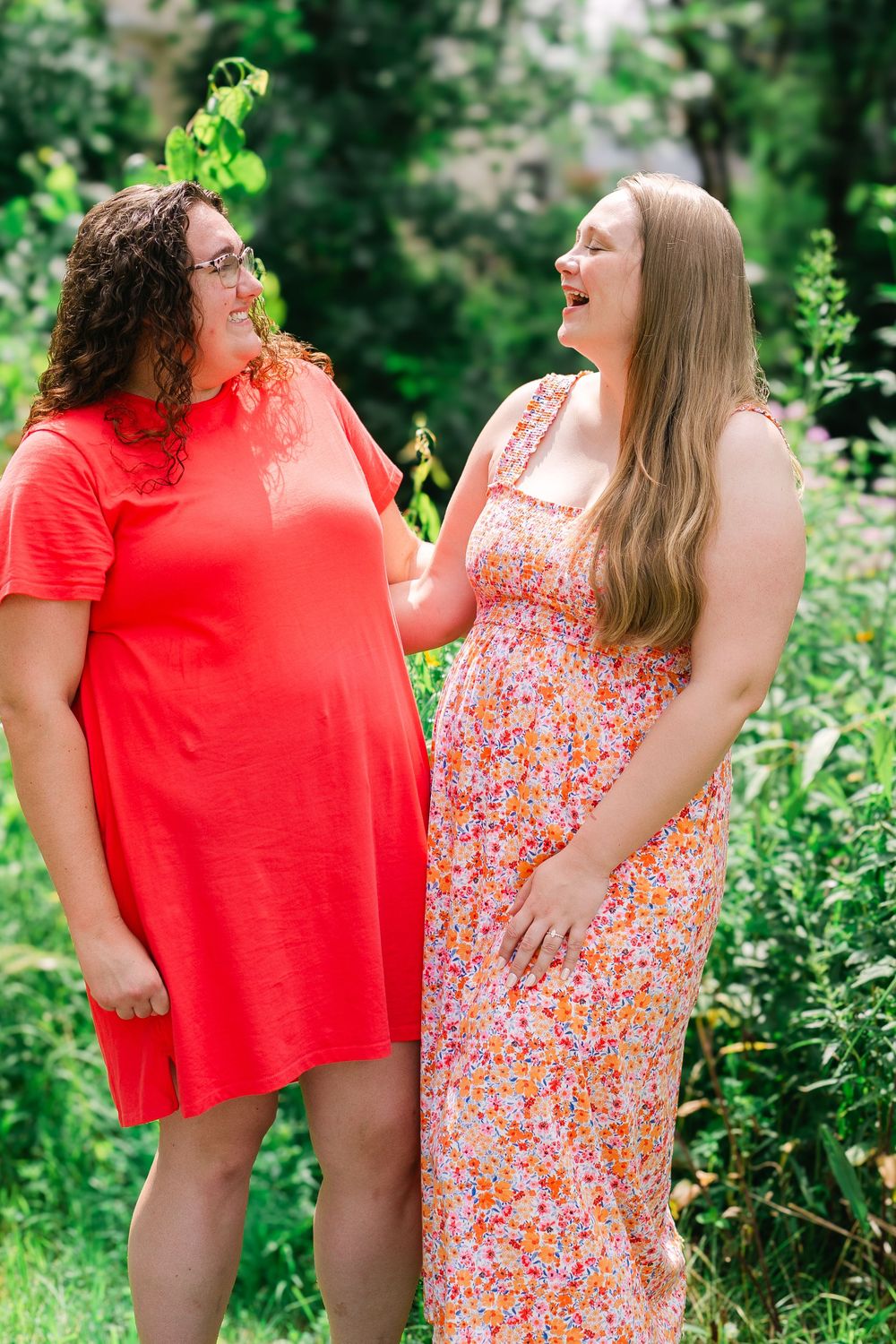 Bride-to-be laughing with her childhood friend during a celebratory engagement gathering in countryside of Victoria, MN