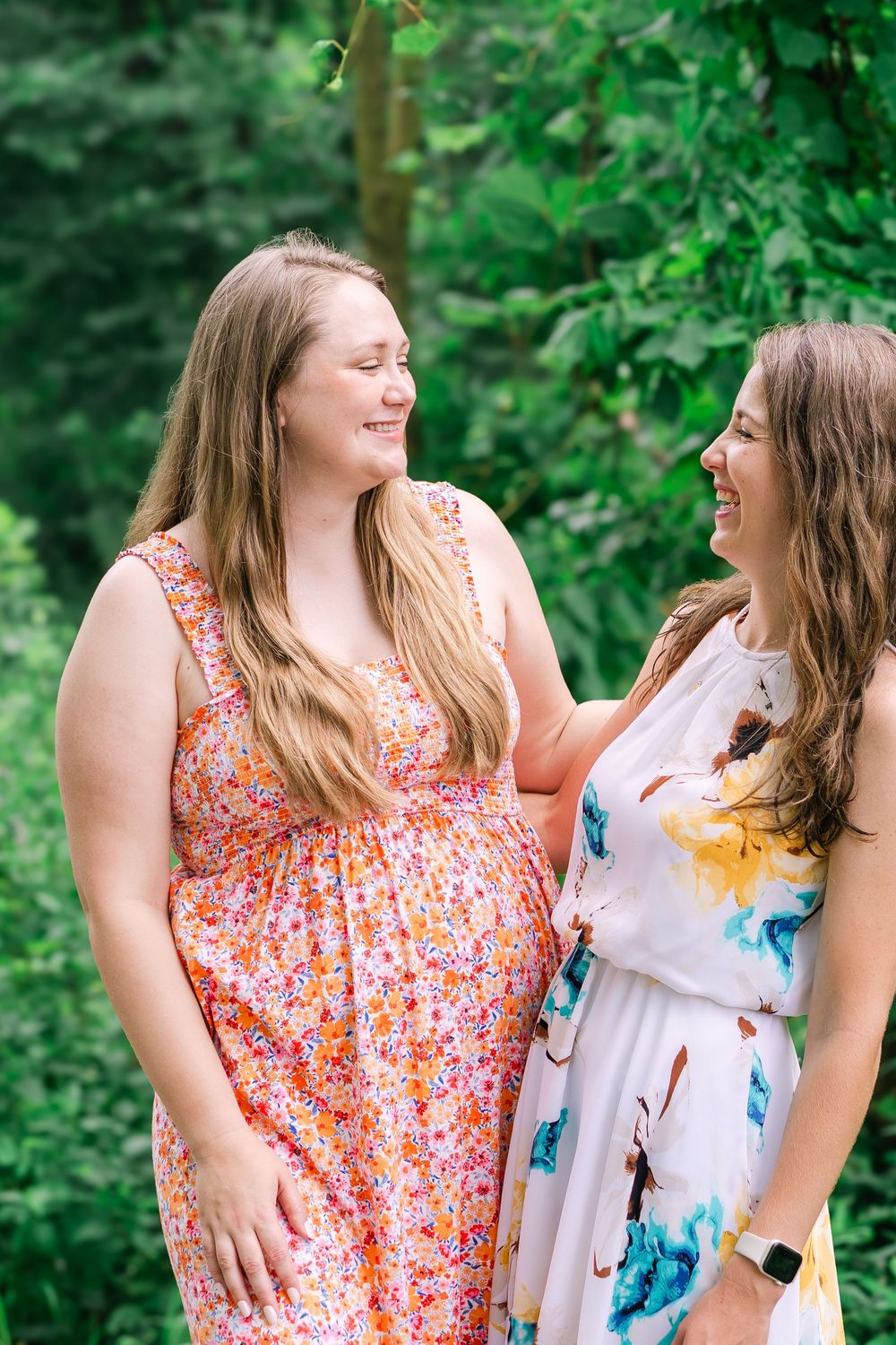 Bride-to-be laughing with her college friend during a celebratory engagement gathering