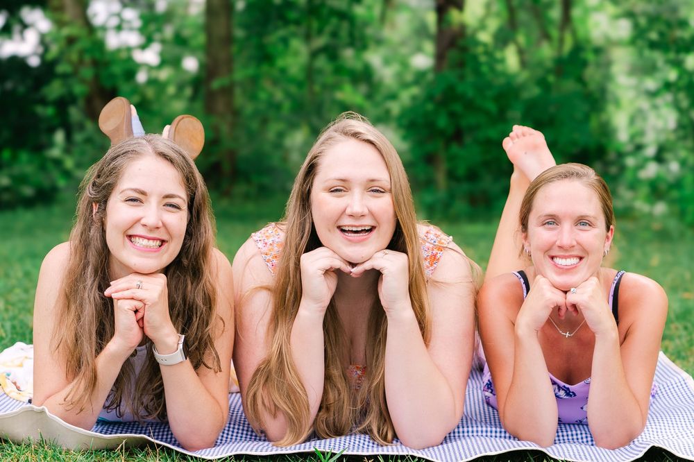 Candid moment of bride-to-be sitting on a blanket, enjoying a peaceful outdoor bachelorette party engagement session outside of Victoria, MN