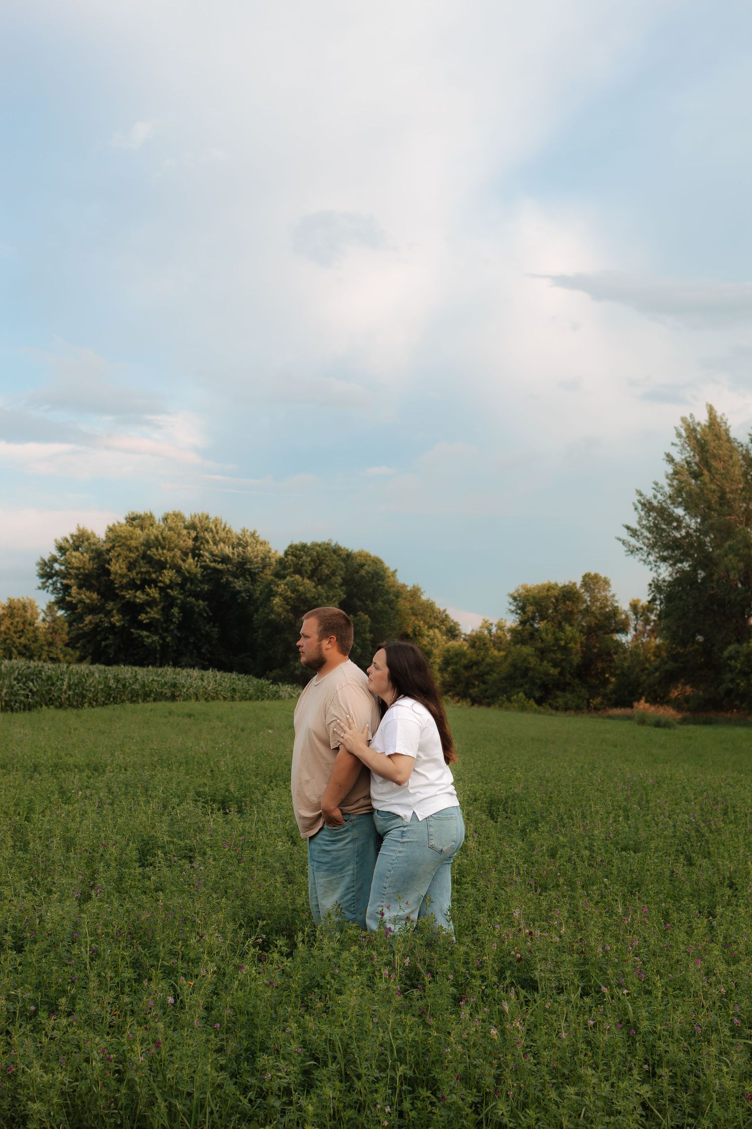 Couple standing in grassy field in their Minnesota and South Dakota Engagement Session