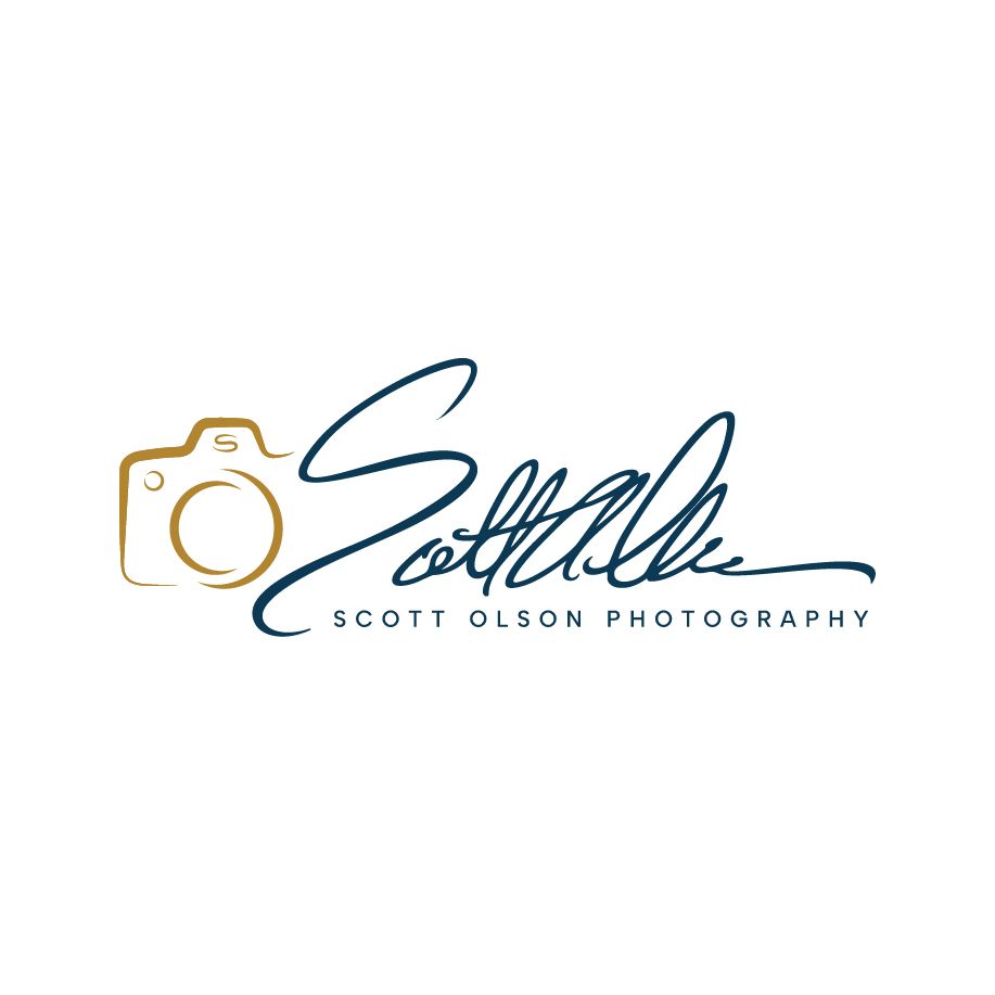 Professional photographer logo design with camera icon and elegant script text in navy blue and gold colors.