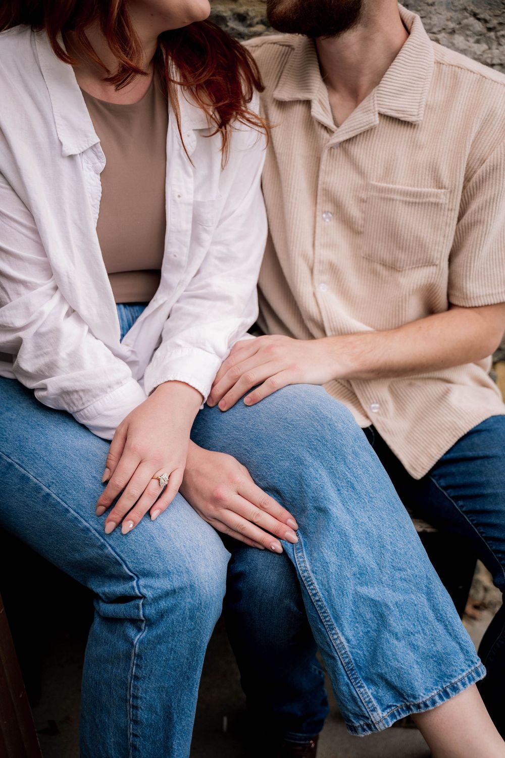 Close-up of couple in casual attire sitting together in denim jeans showing intimacy and connection.