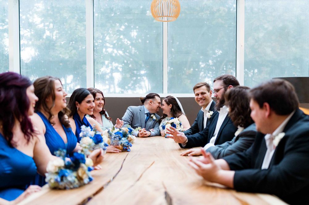 Business professionals sitting at a long conference table engaged in discussion during a corporate meeting.