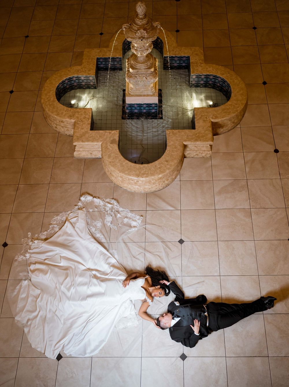 A multi-frame artistic sequence of someone in a long white dress lying on a tiled floor in various dramatic poses.