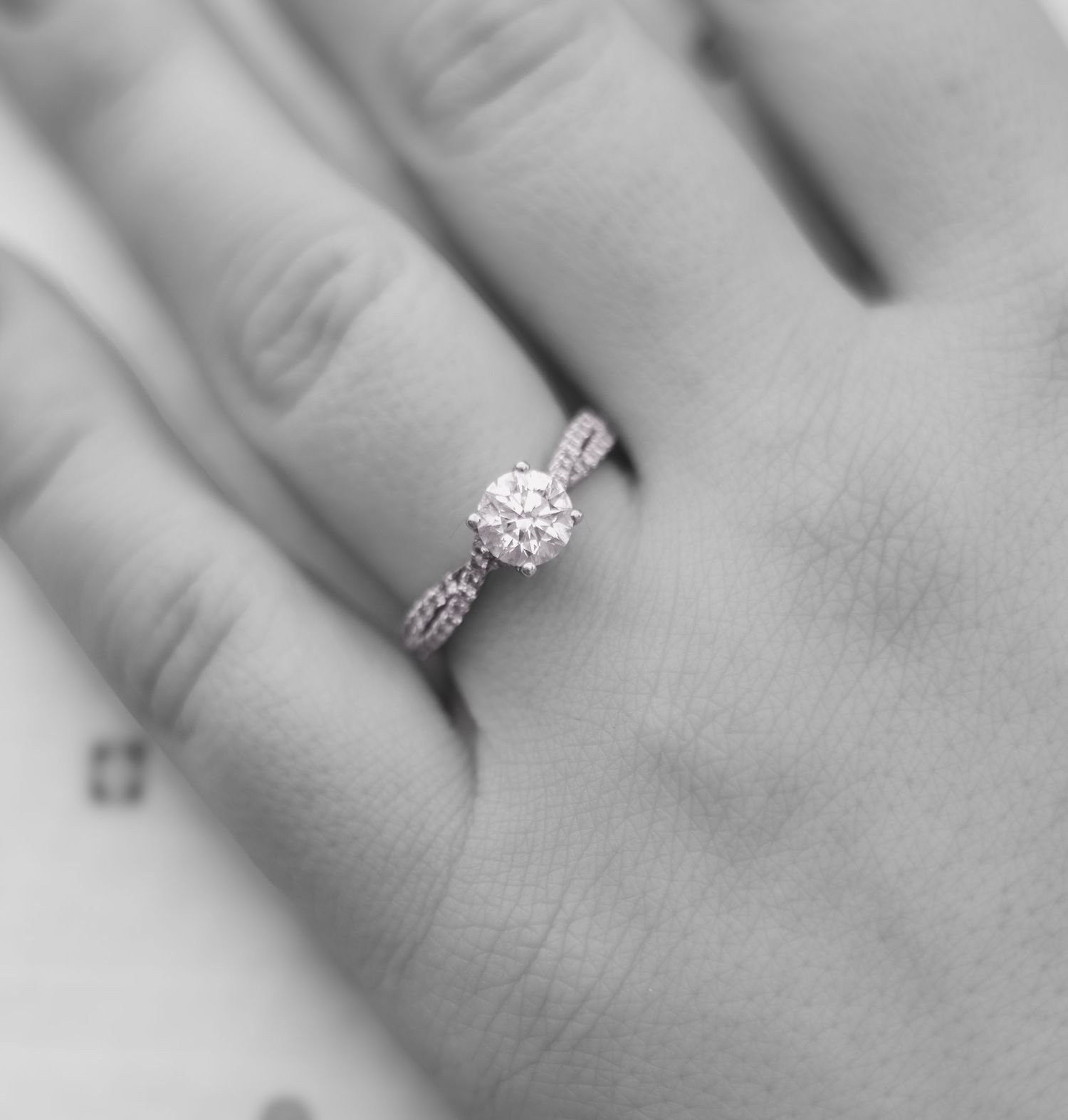 Close-up shots of an engagement ring on a hand showing different angles.