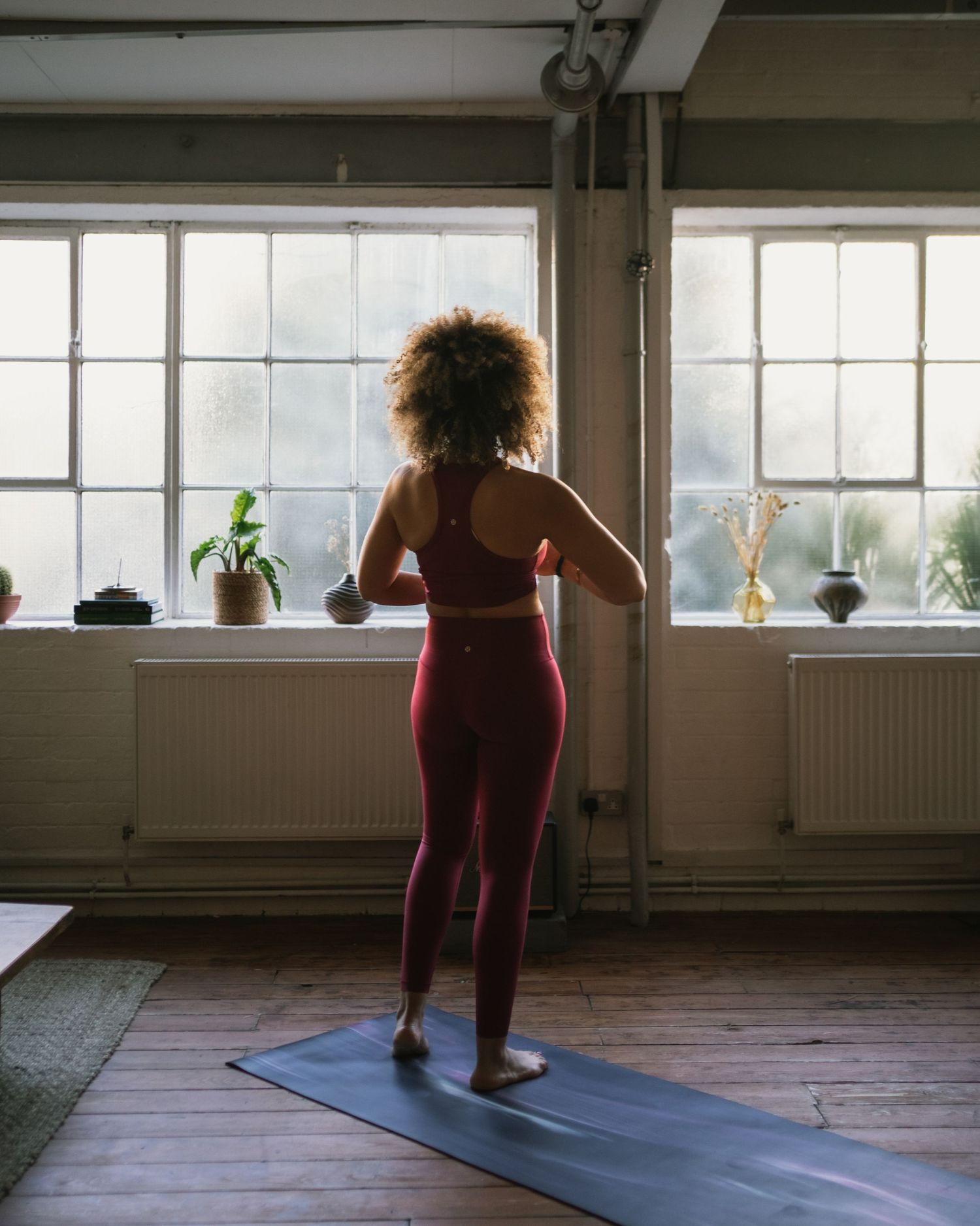 A sequence of low lunges on a yoga mat shows a dynamic fitness flow in a sunlit studio space.