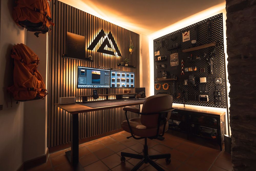 Modern studio office with brick wall, indirect lighting, and high-end audio equipment for podcast recording setup.