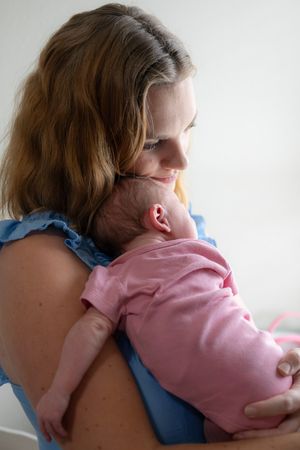 Tender moments between parent and baby in soft natural light.