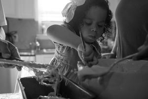 A series of intimate black and white photographs showing tender moments between a couple.