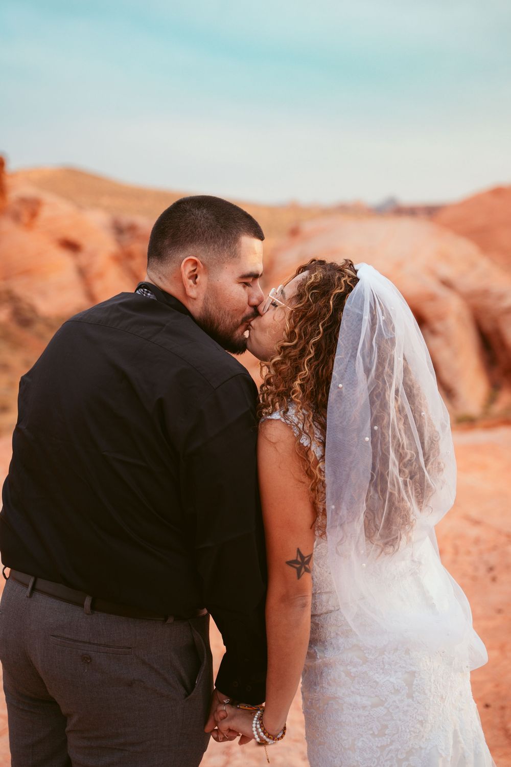 A romantic wedding photography sequence shows tender moments between newlyweds in a desert landscape.