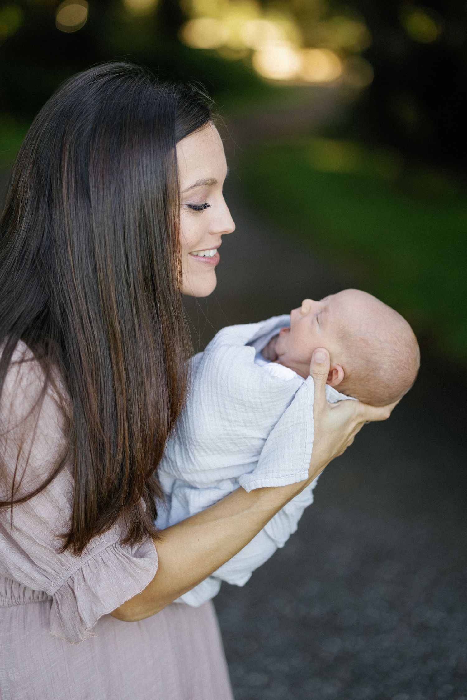 A mother lovingly looking at her newborn baby during an outd