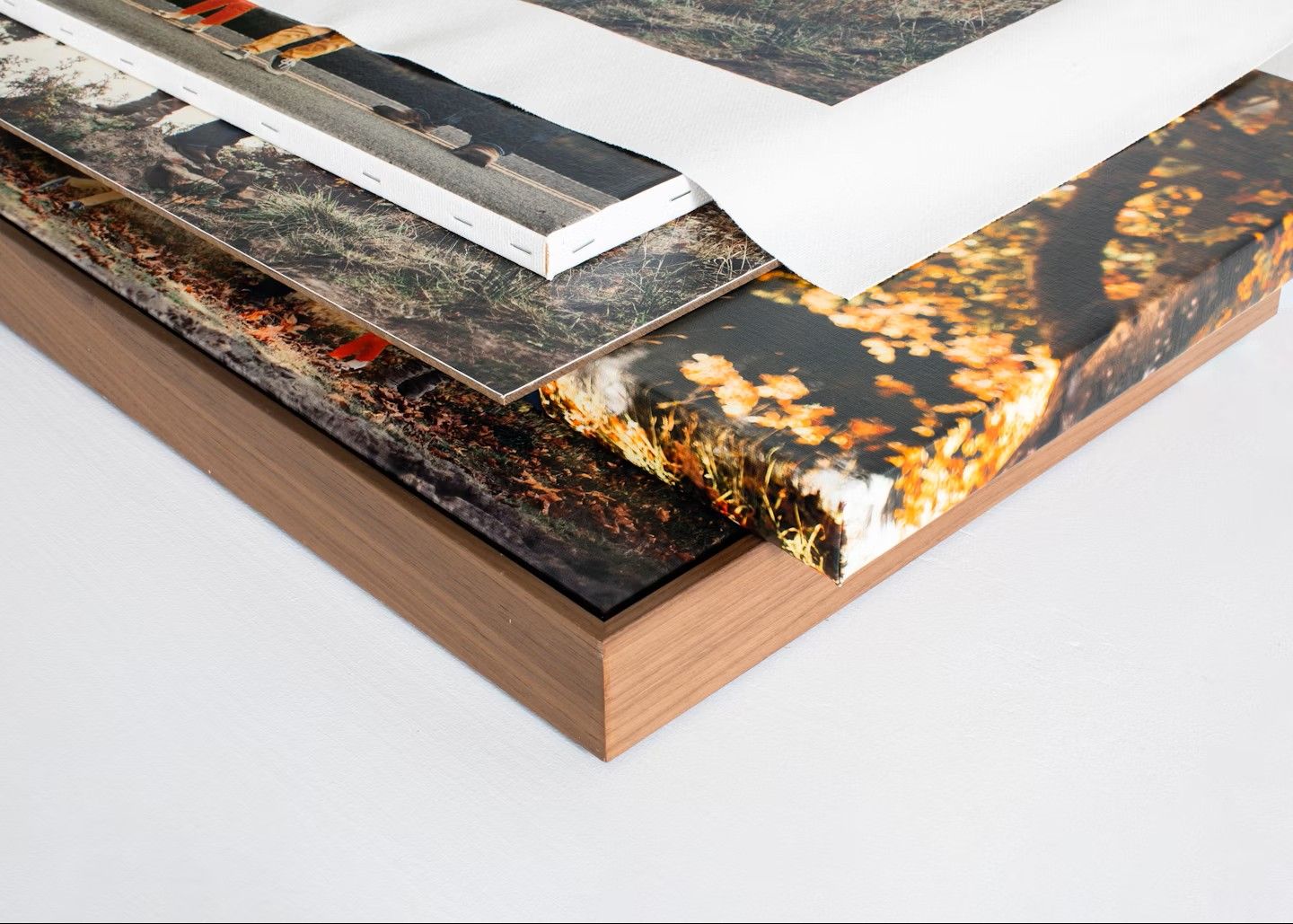 Close-up view of mounted photo prints showing textured edges and wooden block mounting details.