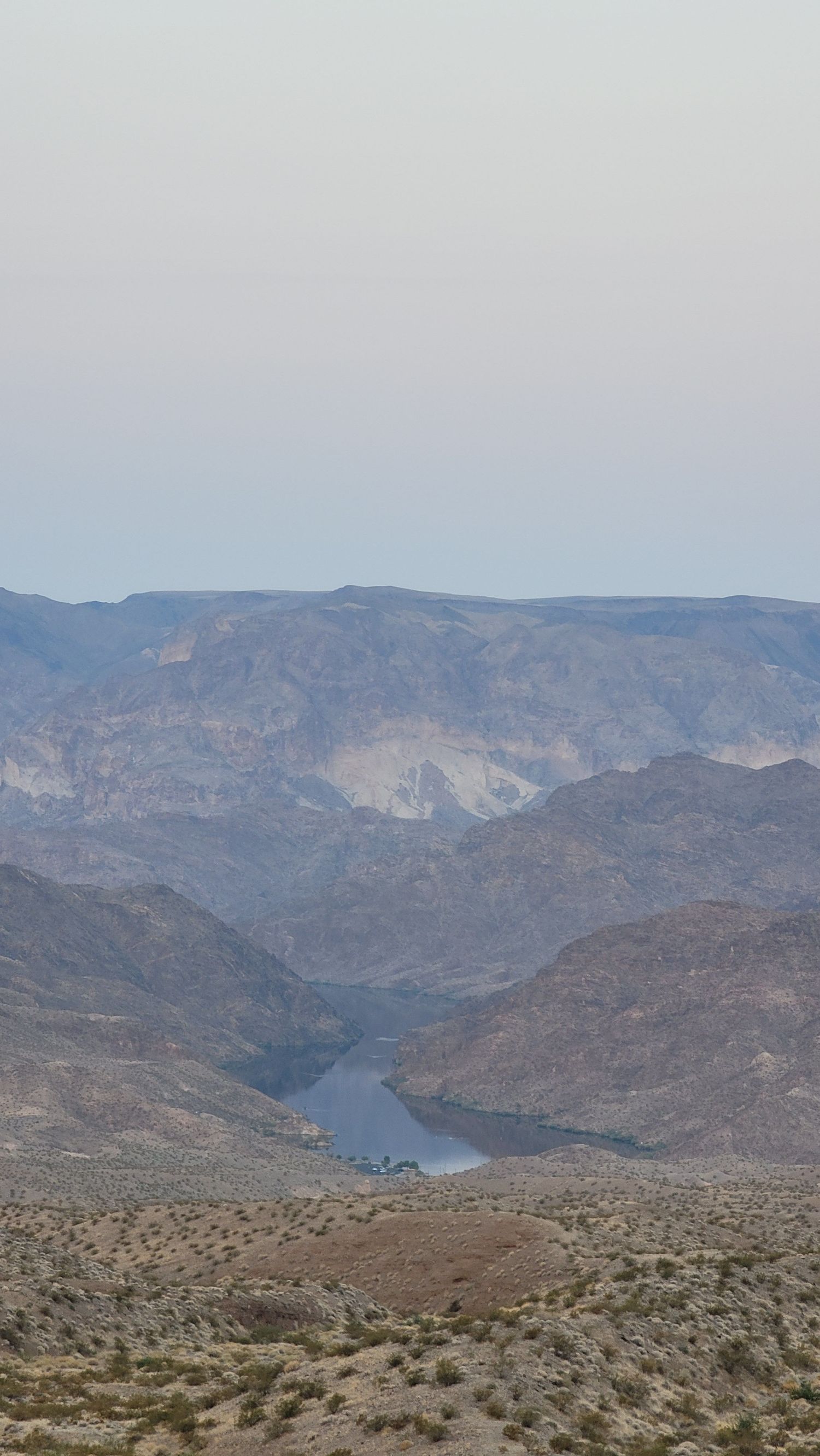 Expansive desert canyon view with rugged cliffs and river below in the Southwest