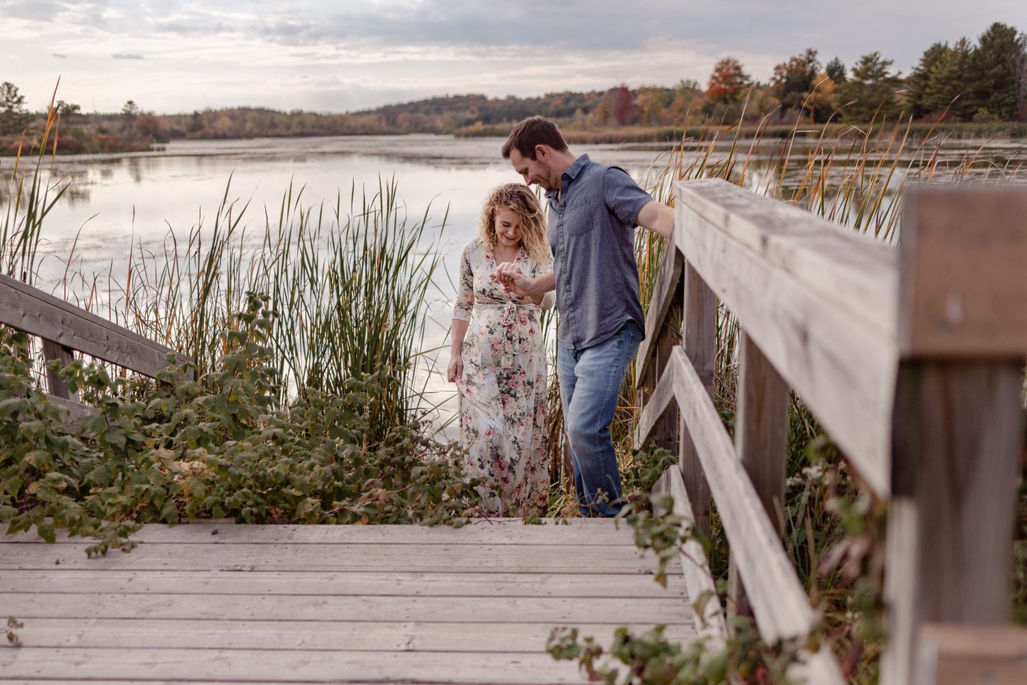 couple stroll along marshland in conservation area trail near kingston ontario