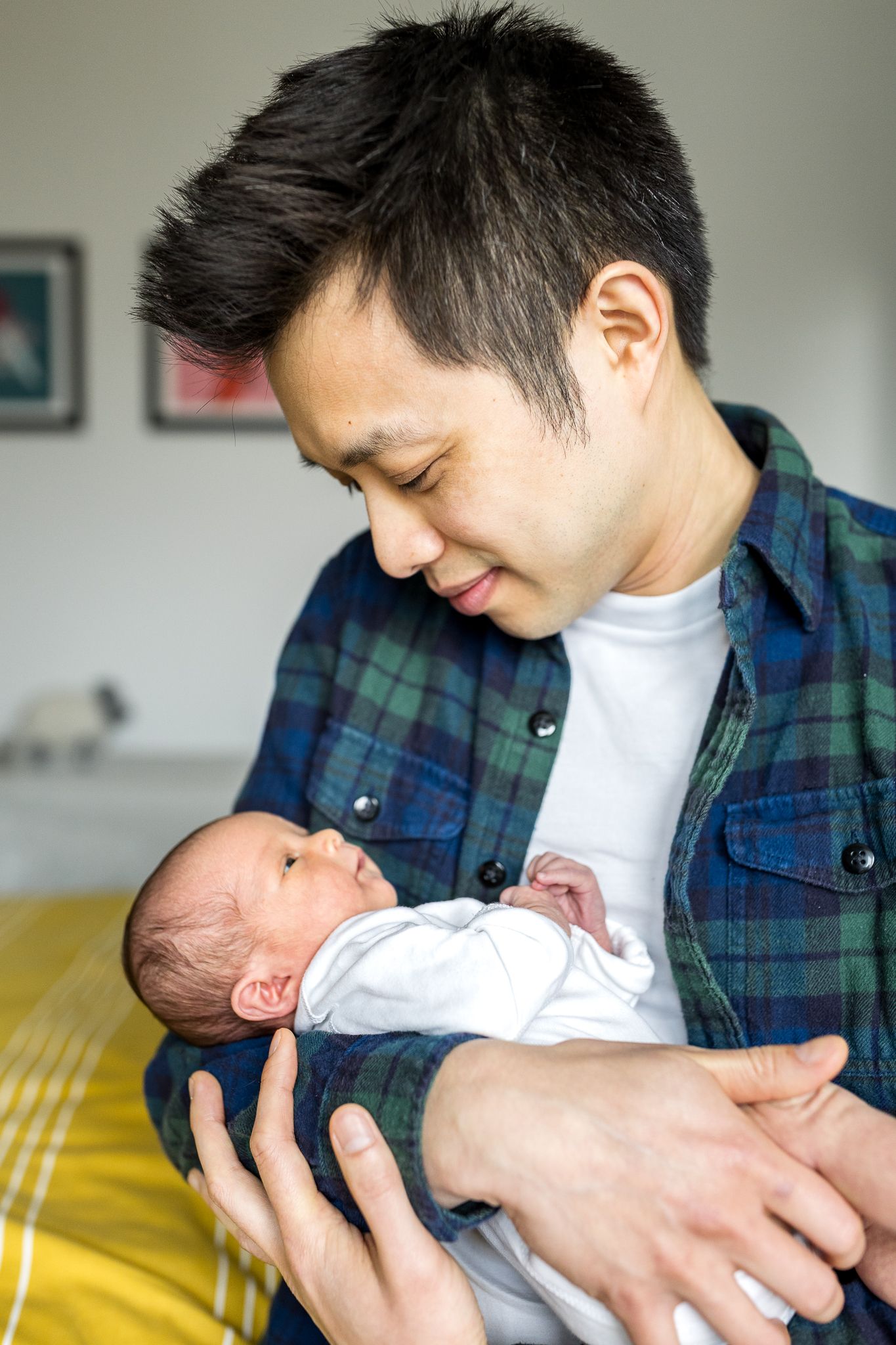 dad holding his newborn baby girl daughter