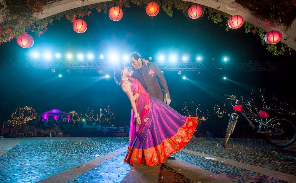 Indian groom holding the bride at the sangeet event