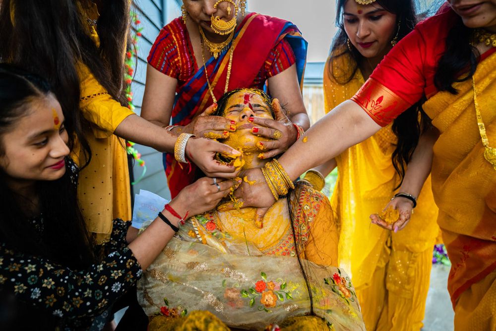 Indian bride having Haldi applied by her relatives during the Haldi ceremony at a wedding in Wellington, New Zealand.