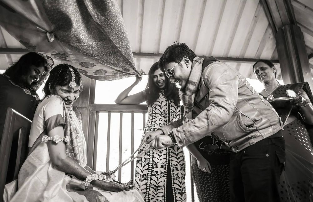 Black and white photo of a bride smiling during her Haldi ceremony in Wellington, New Zealand.