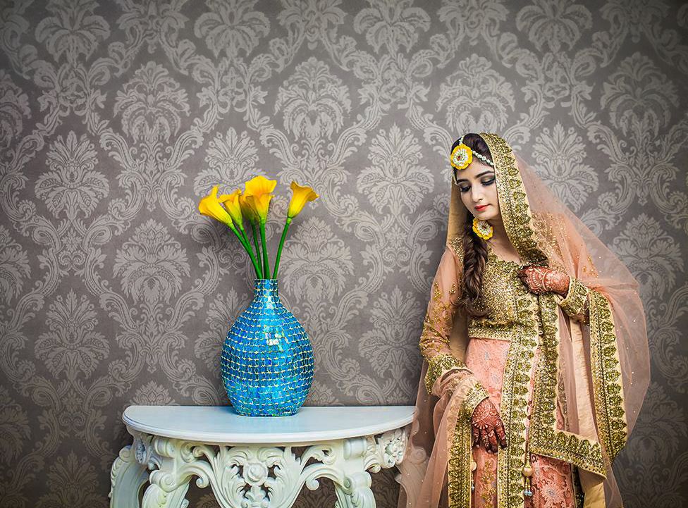 A series of wedding photos against a damask wallpaper showing floral arrangements, traditional attire, and decor details.