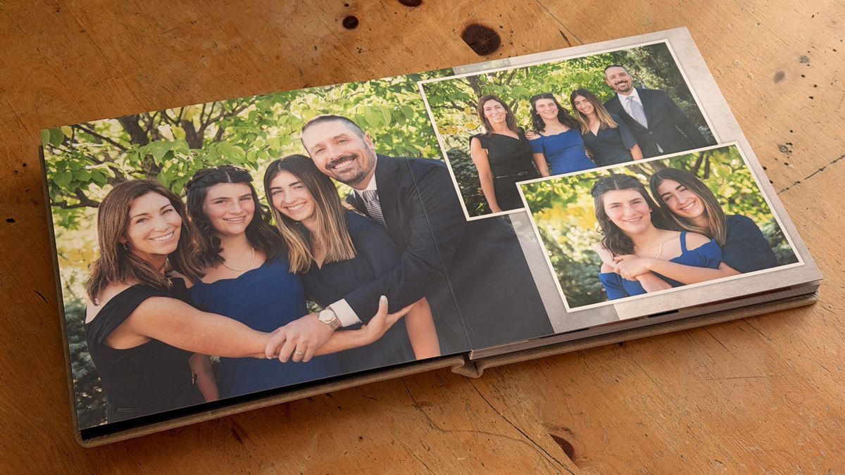 A collection of photo prints arranged in a row on a textured wooden surface.