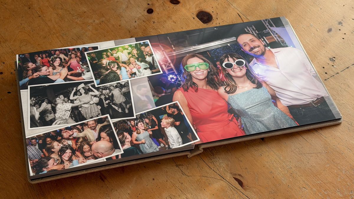A photo album displaying multiple candid party and celebration pictures laid open on a wooden surface.