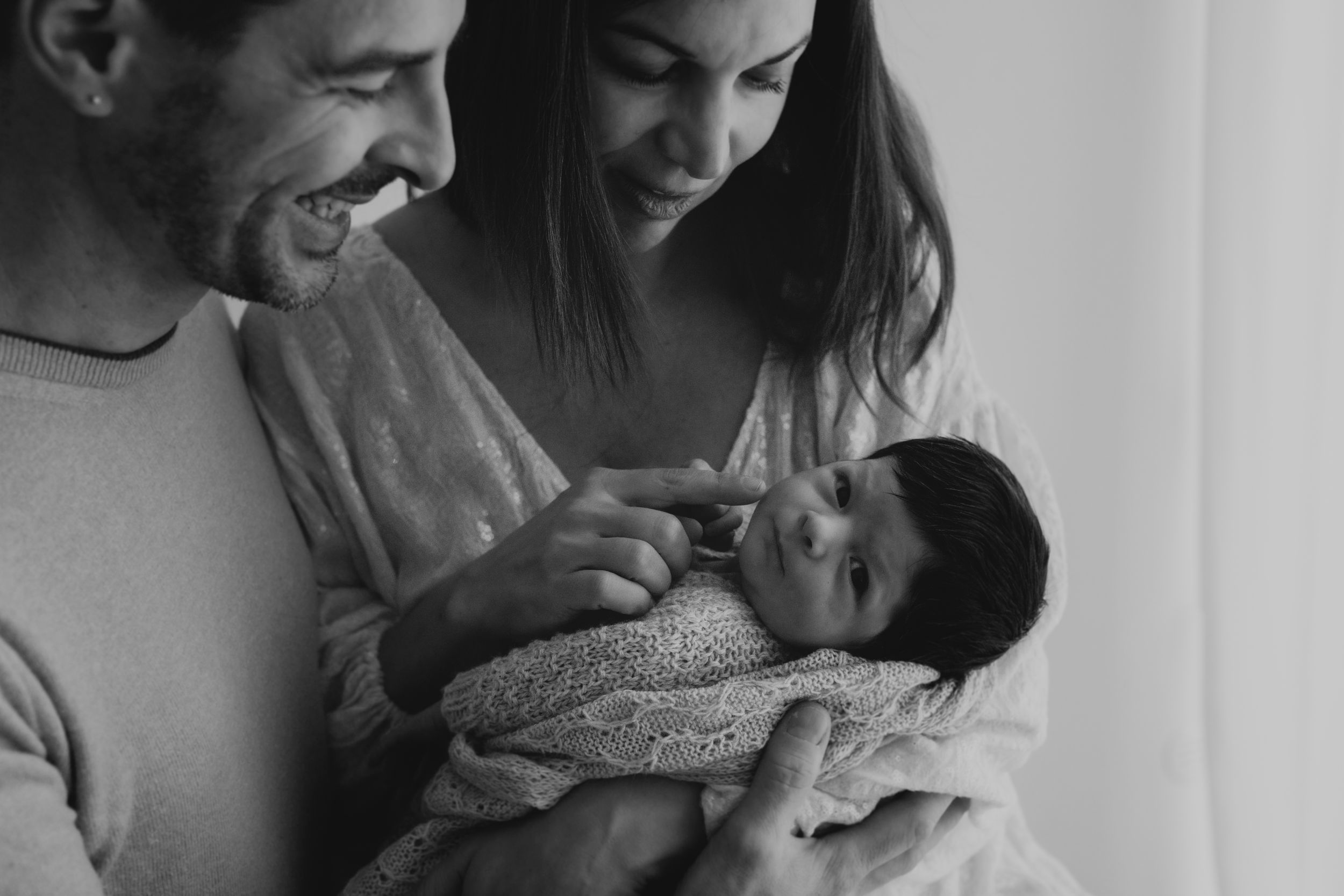 Black and white photo series showing intimate wedding moments with couples embracing and sharing tender moments.