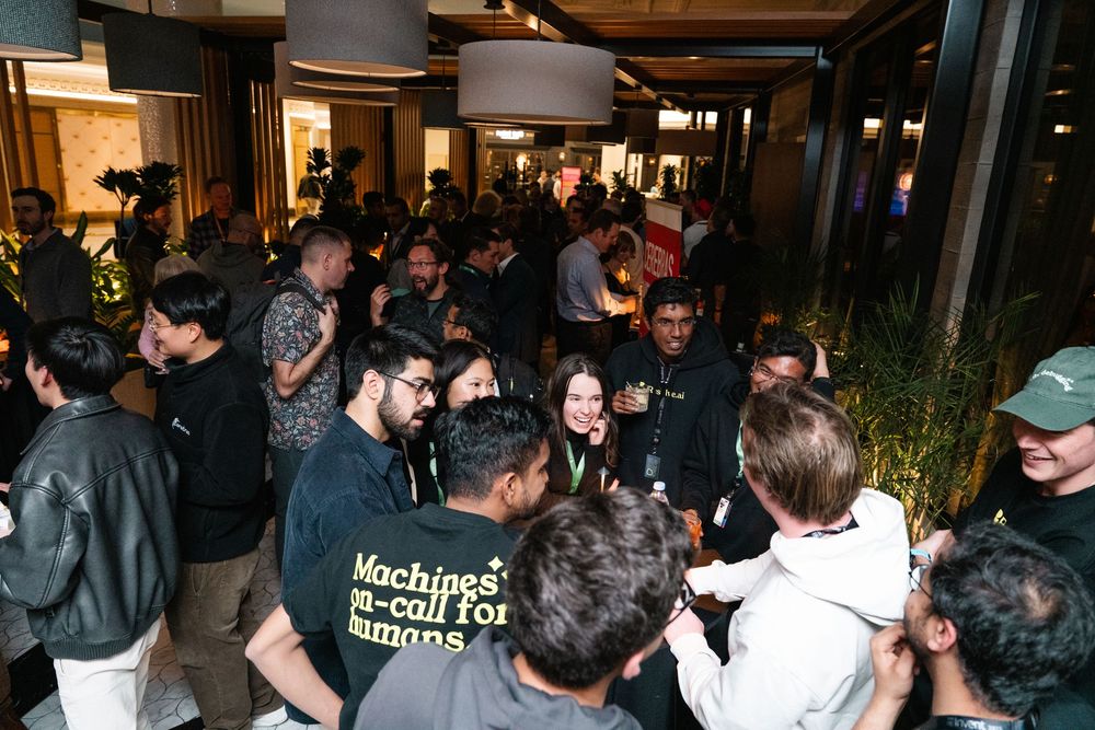 A crowded indoor venue with people gathered in casual attire during what appears to be a social event or gathering.