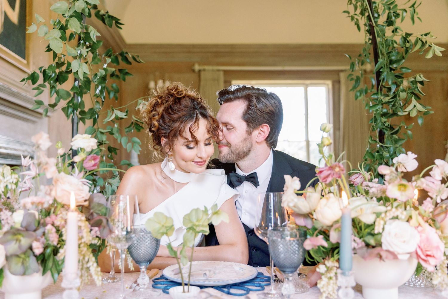 A romantic wedding reception scene with couples sharing tender moments at a beautifully decorated indoor venue.