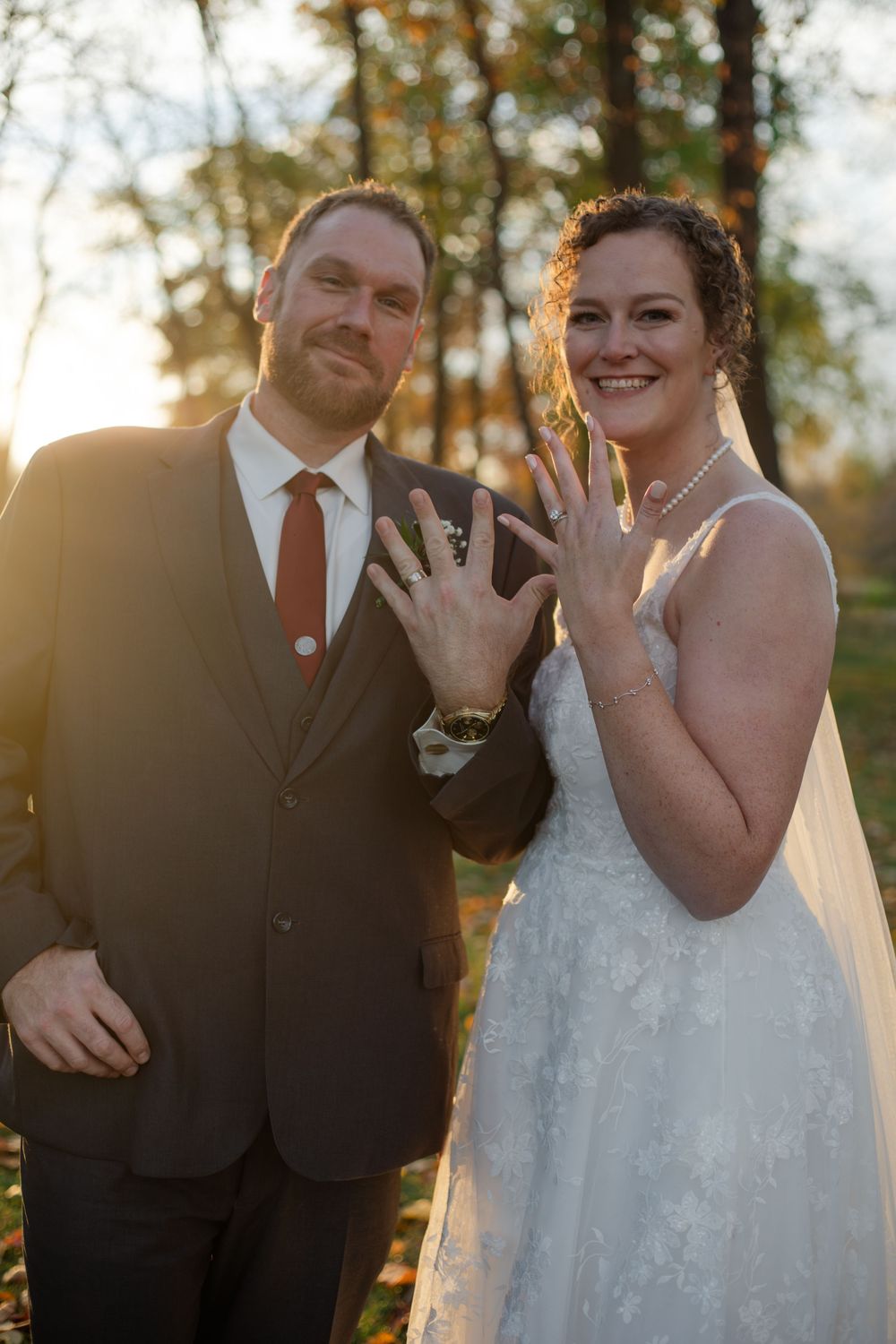 A joyful wedding couple sharing laughs during their sunset photo session.