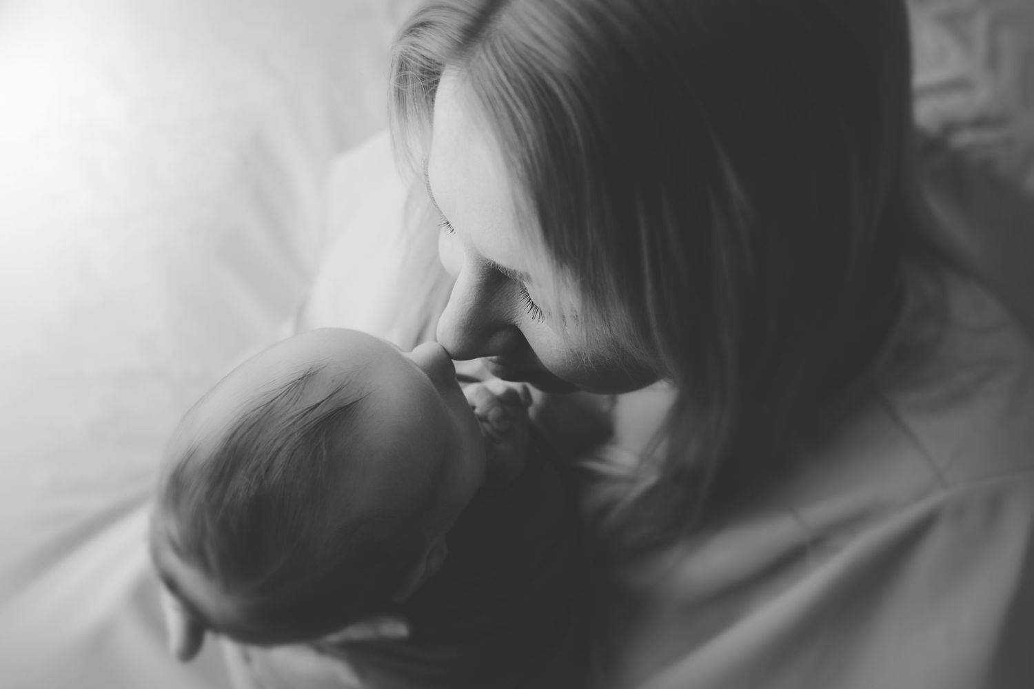 A black and white photo series showing close-up expressions of emotion and connection between two people.