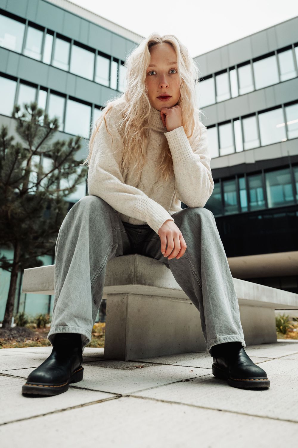 Fashion photo series showing white sneakers and gray pants against modern architectural backdrop.