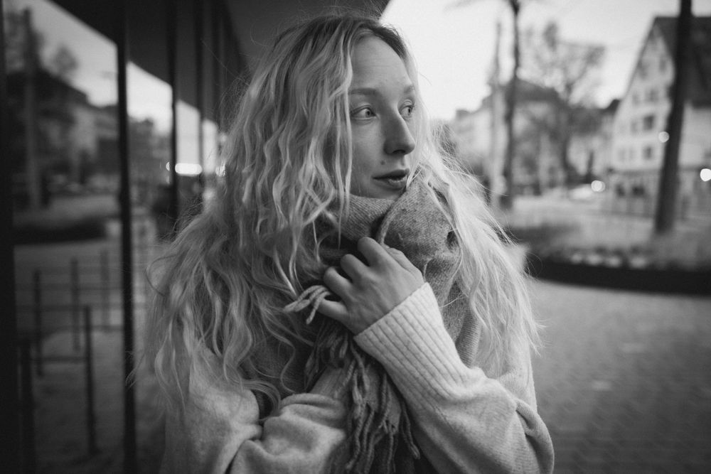 A collection of black and white artistic portraits showing close-up emotional expressions and poses in an urban setting.