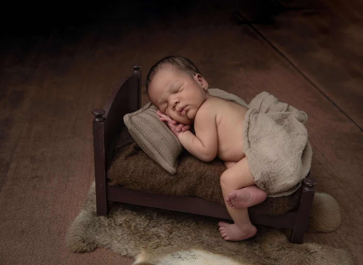 A series of images showing a baby crawling and exploring a hardwood floor with a playful and curious demeanor.