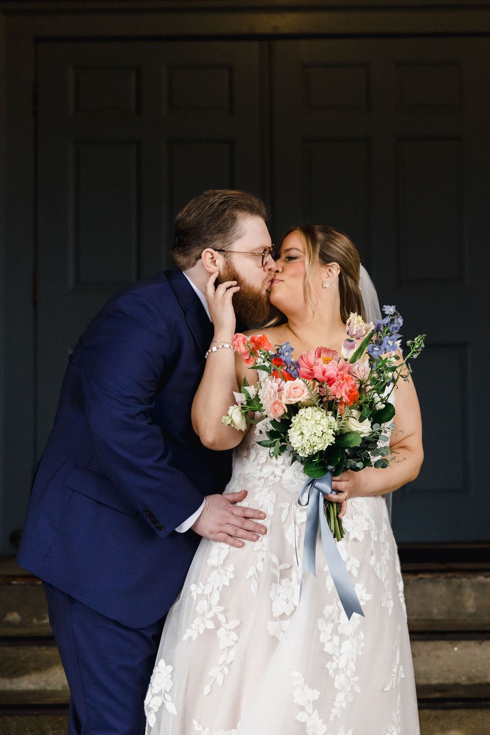 Four sequential photos show a romantic wedding kiss with coral and white floral bouquet against a dark background.