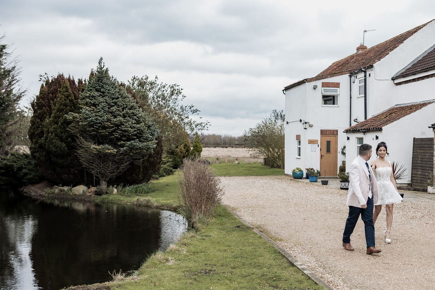 Bride and groom walking together at Deighton Lodge spring styled shoot.