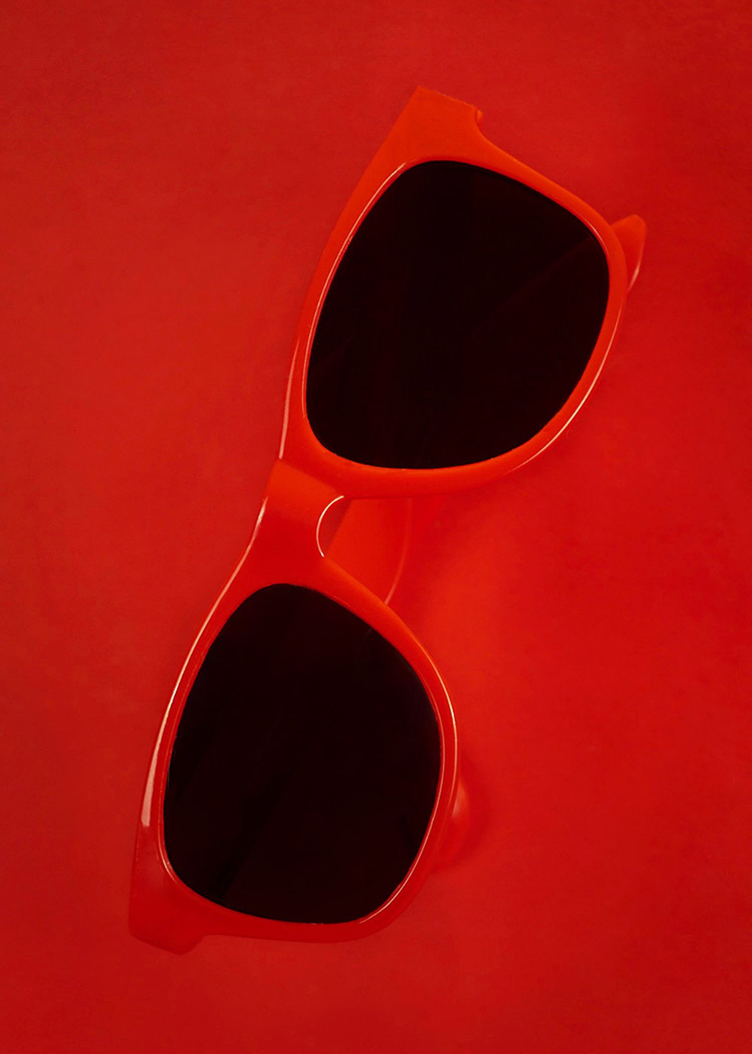 Product photography featuring a pair of red sunglasses, created by commercial photographer Chris Z of Zeng Studio.