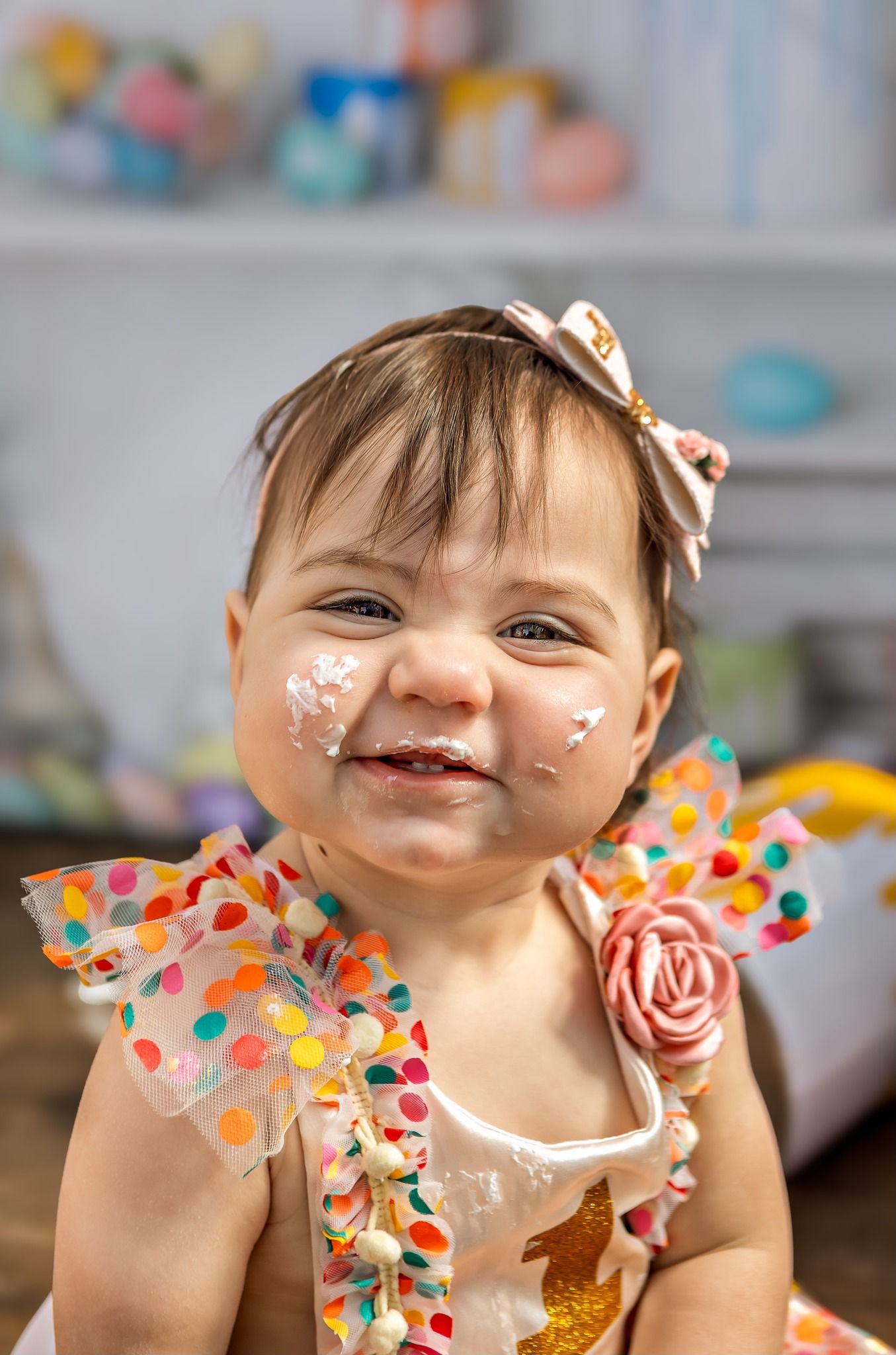 Festive birthday celebration with colorful polka dot outfit and sparkly face decorations.