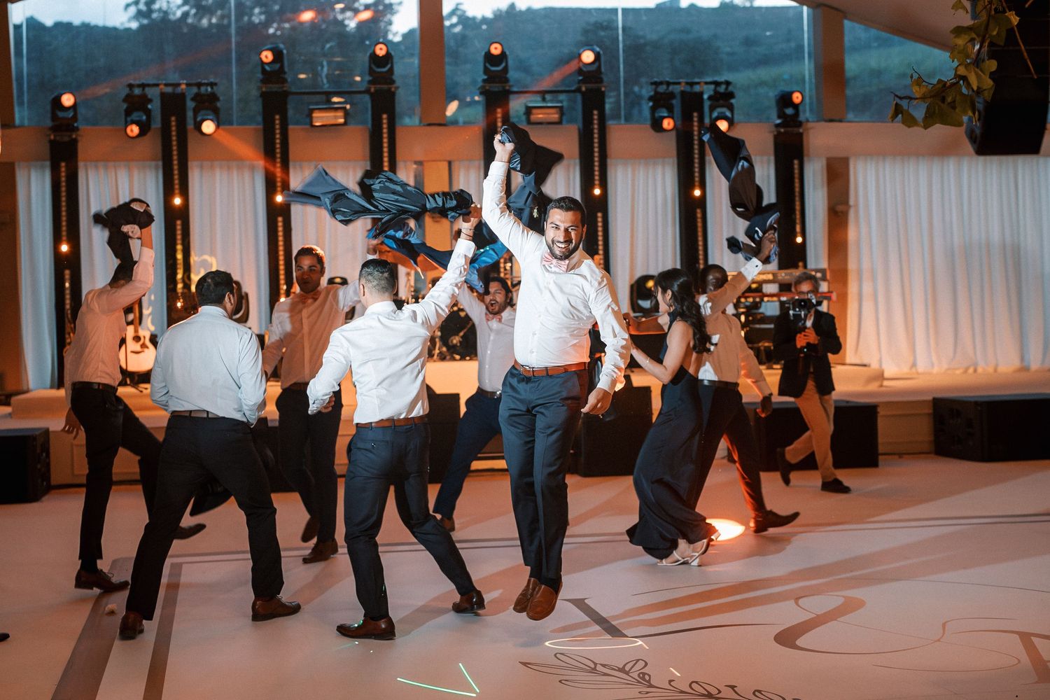 Energetic groomsman party entrance at luxury Indian destination wedding in Portugal
