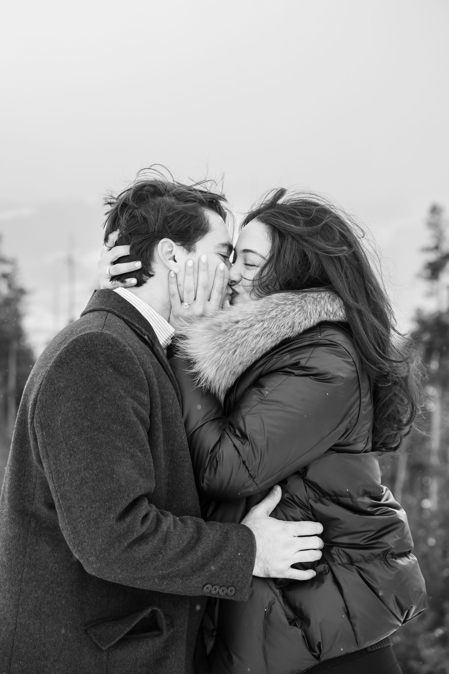 Black and white passionate engagement photos with cute couple after a surprise proposal at Sapphire Point in Colorado.
