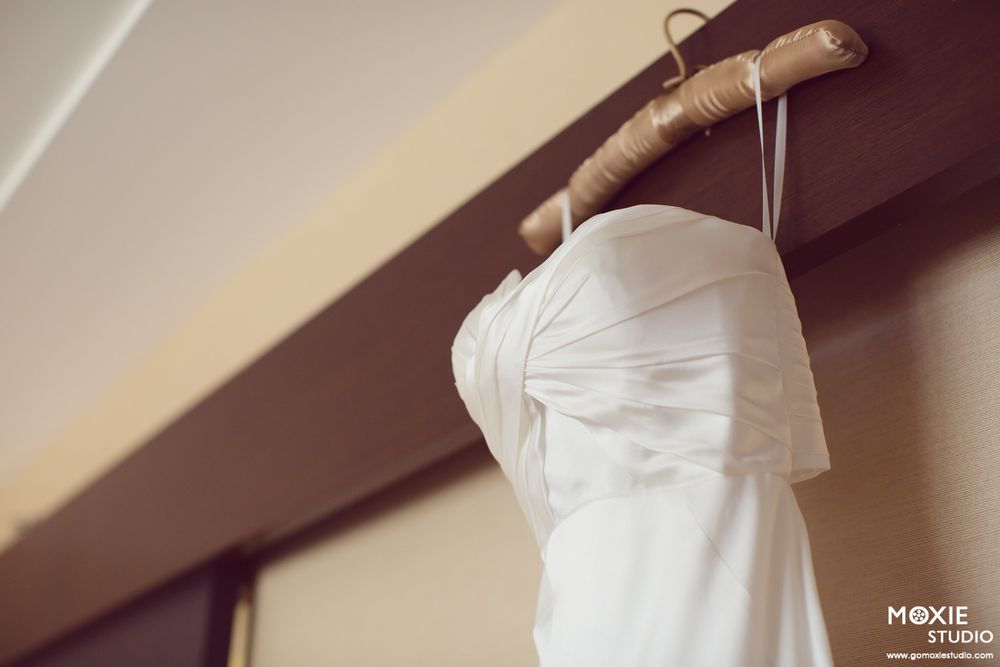 Elegant white wedding dress details showing intricate fabric folds and textures.