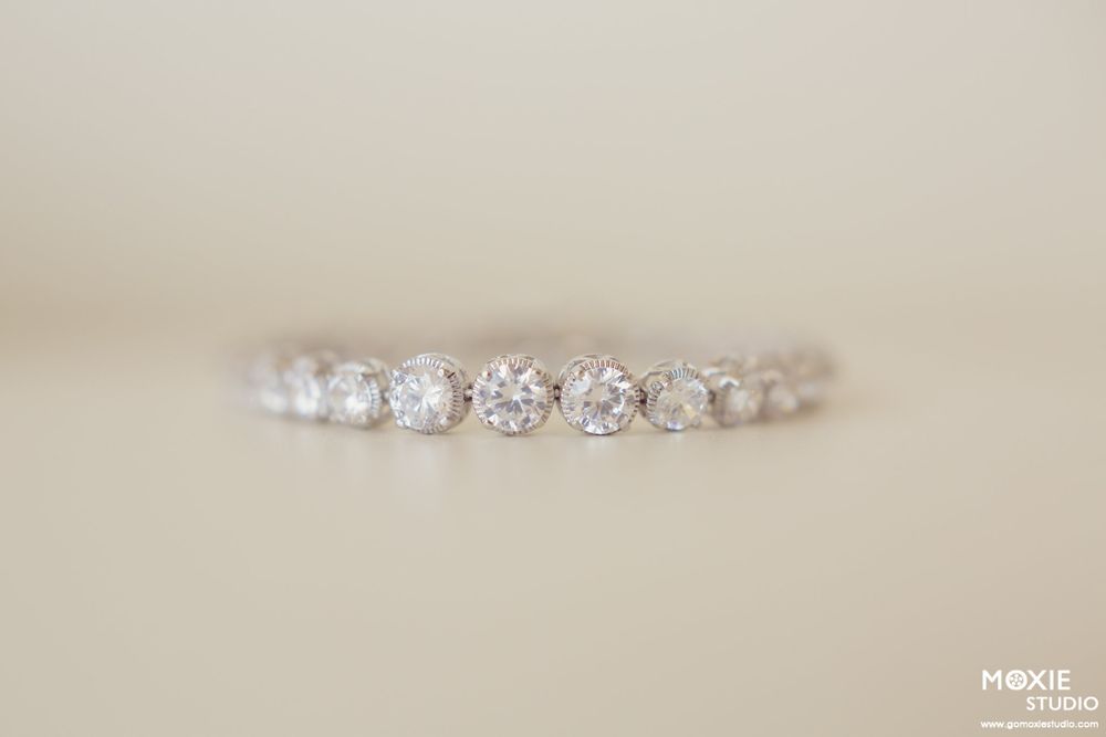 Delicate crystal wedding tiara or headpiece displayed on a light neutral background.