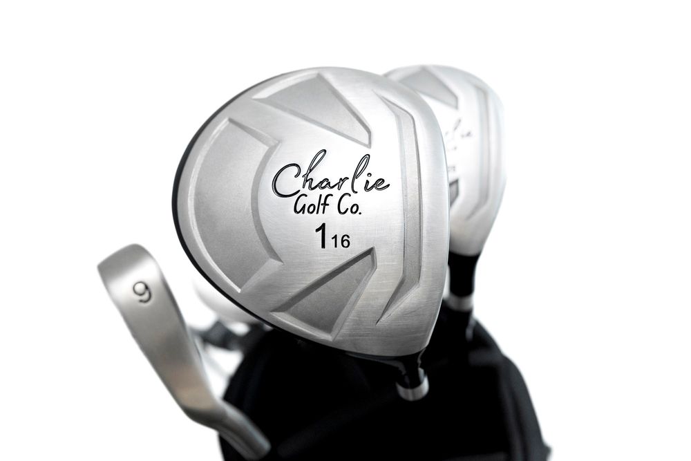 Close-up view of a white golf driver club head with Charlie Golf Co branding against white backdrop