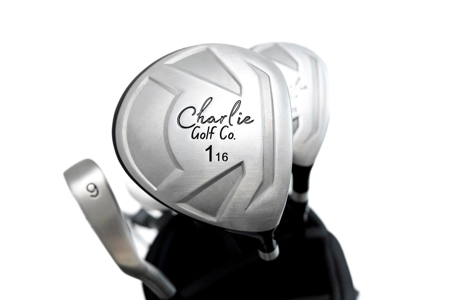 Close-up view of a white golf driver club head with Charlie Golf Co branding against white backdrop
