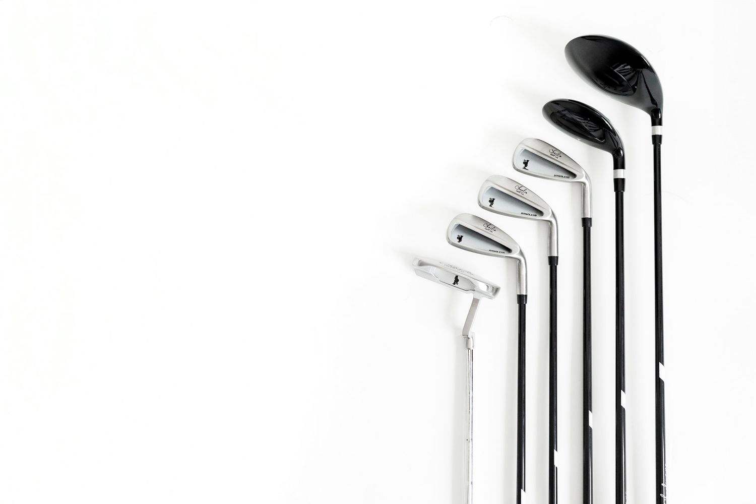 A collection of golf clubs arranged in ascending order against a white background from Small business product photoshoot for branding