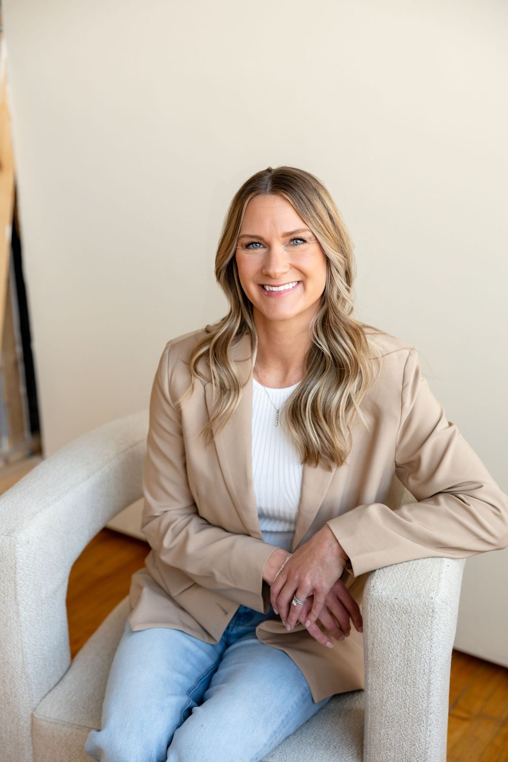 Professional lifestyle photo series showing casual business attire with beige blazer and light denim in bright interior setting.
