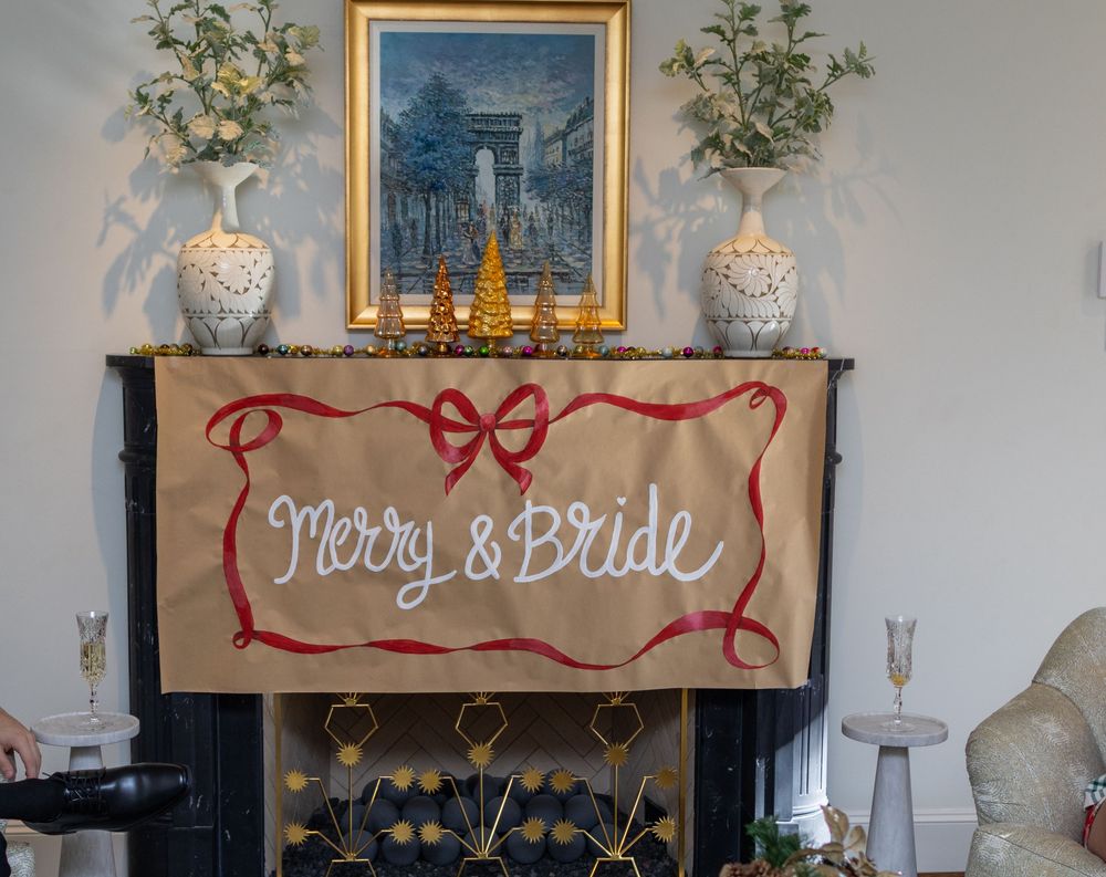 A rustic wedding decor display with 'Groom & Bride' sign on burlap, flanked by elegant vases and artwork.